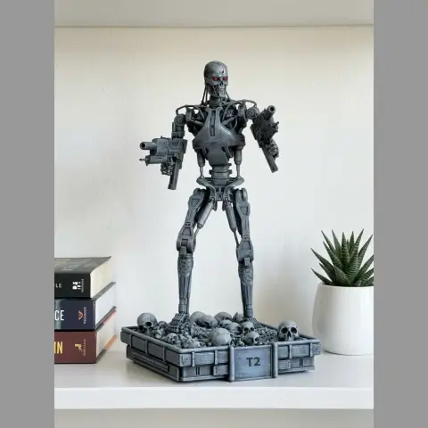 A robotic skeleton with guns stands on a base adorned with skulls, in a 3D model for printing.