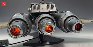 Back view of a Star Wars-inspired triple-engine space fighter model with glowing orange exhausts.