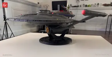 A detailed 3D-printed model of the Star Trek Enterprise NX-01 Refit on a display stand.