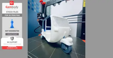 A 3D-printed tuk tuk model on a printer bed, featuring functional steering.