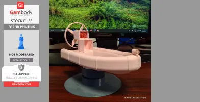 Realistic 3D-printed airboat toy with fan, displayed on a desk in front of a monitor.