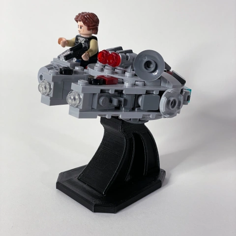 LEGO-style spaceship model on a black stand with mini figure pilot, ready for display.