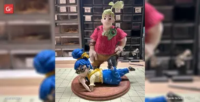 Two stylized figures on a diorama base; one standing, one lying down, with colorful outfits and accessories.