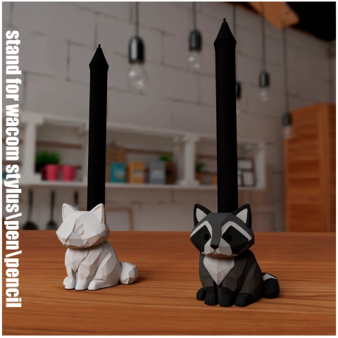 Stylized raccoon pen holders in black and white, placed on a table with background decor.