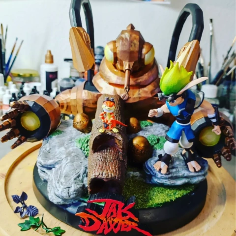 A detailed 3D diorama featuring characters and a robotic creature from 'Jak and Daxter,' with a logo base.