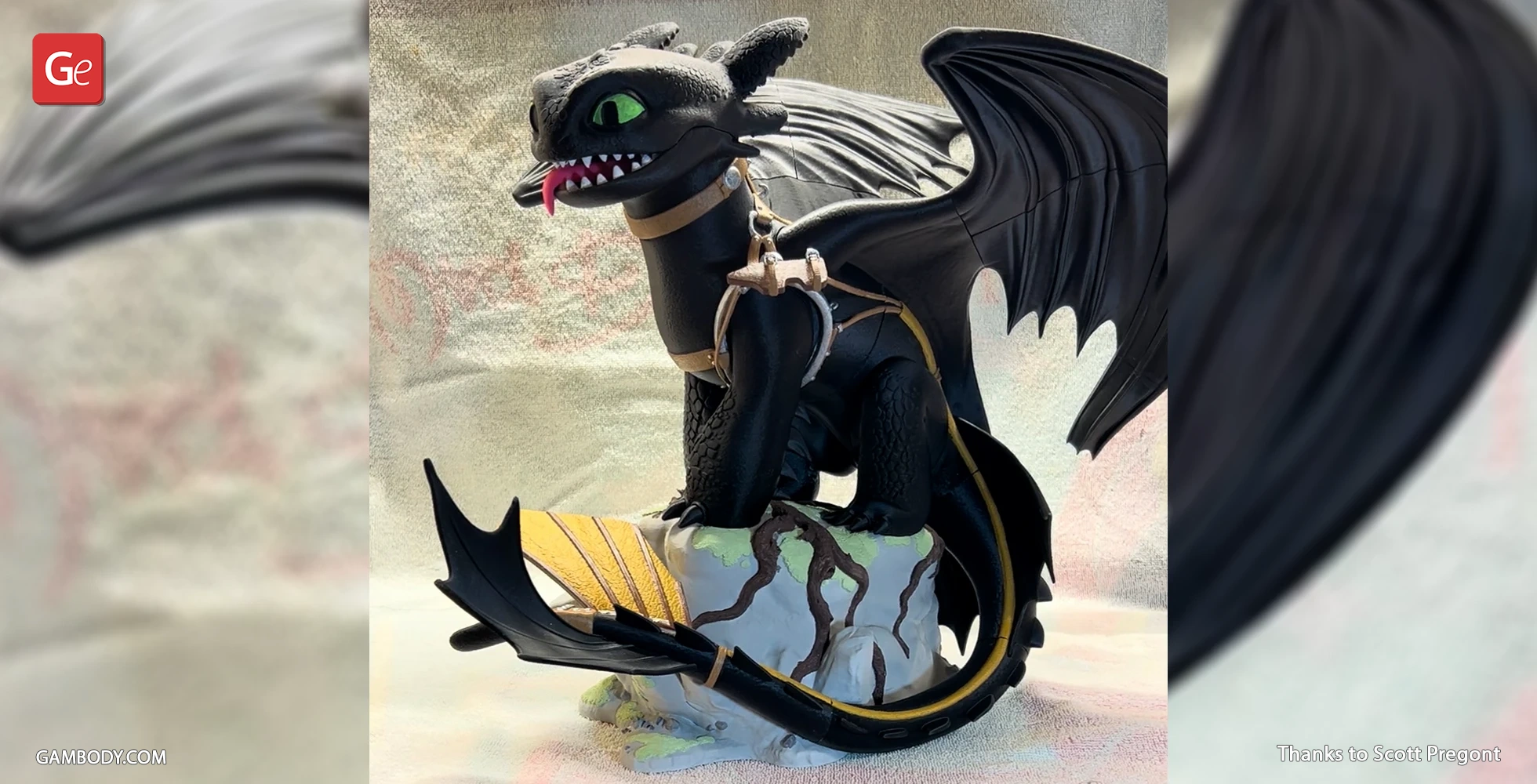 A 3D model of Toothless, the Night Fury dragon, with harness, sitting on a rock.