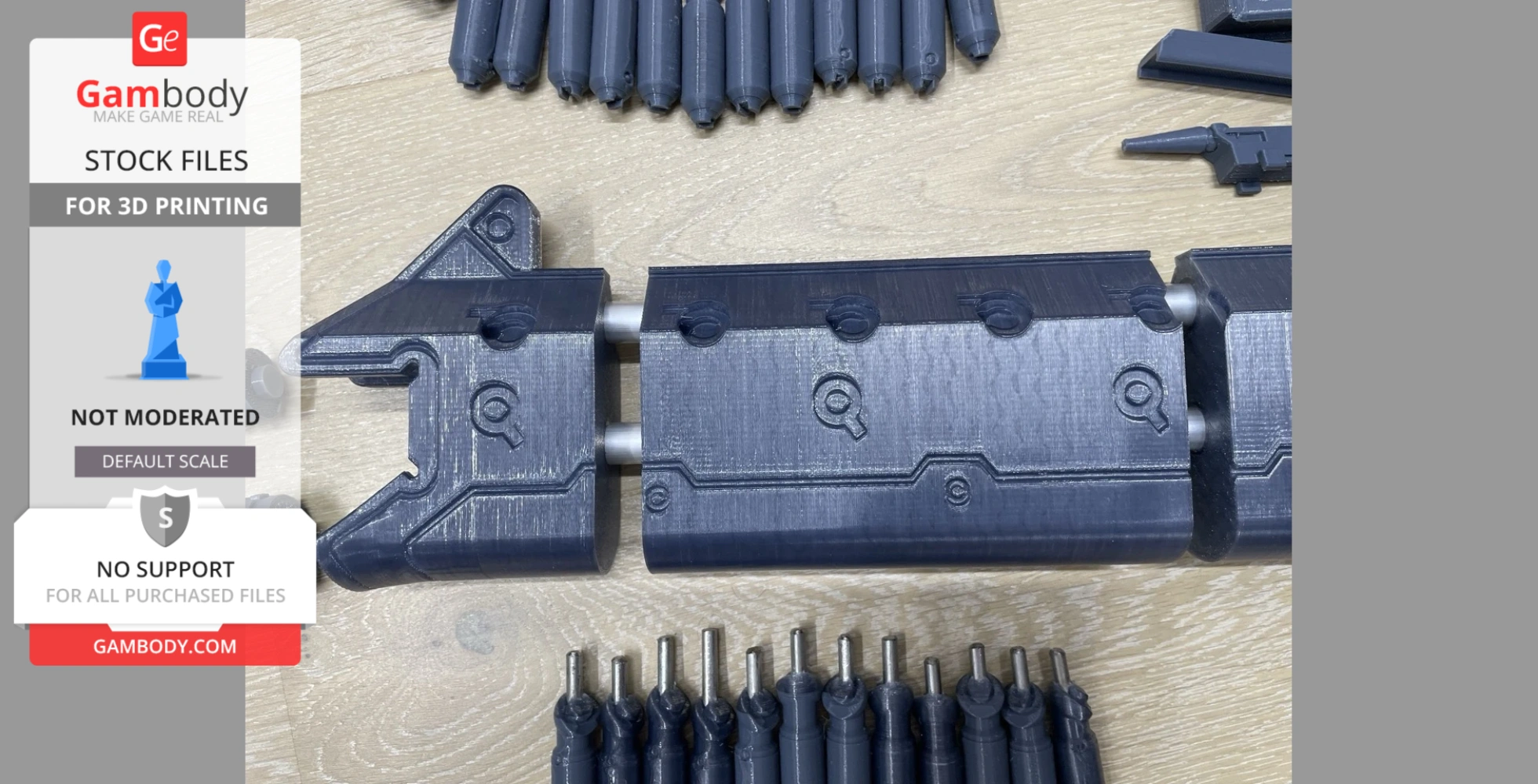 3D-printed parts for a District 9 assault rifle model, arranged on a wooden surface.