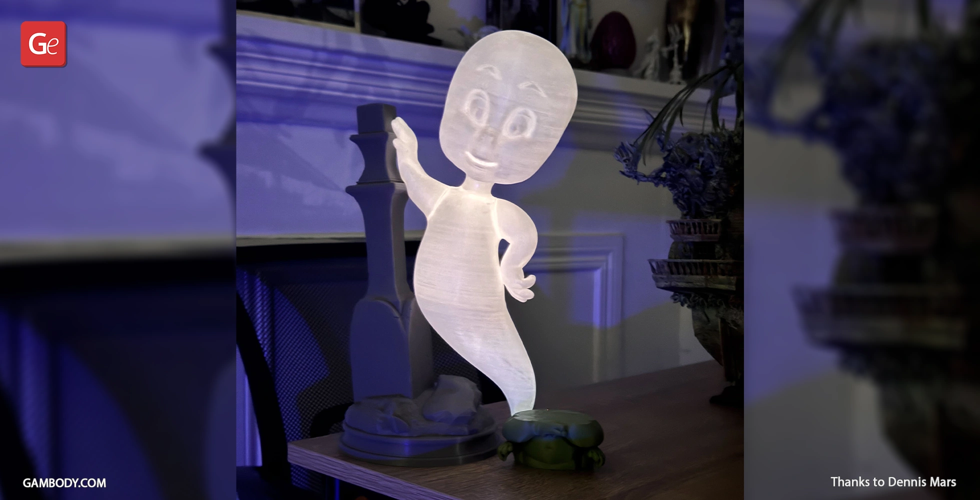 A glowing 3D printed cartoon ghost in a playful flying pose on a tabletop.
