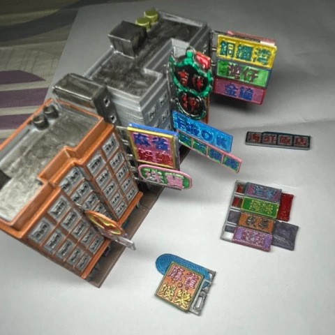 A 3D printed sheet of intricate Hong Kong-style signage and architectural details in white plastic.
