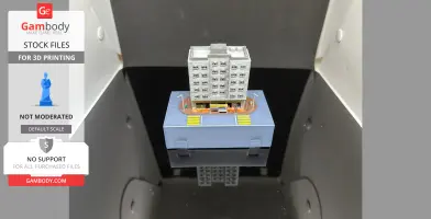 3D-printed Hong Kong-style apartment building on a small platform with streets and figures.