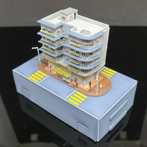 Detailed miniature model of a Hong Kong building on a display base.