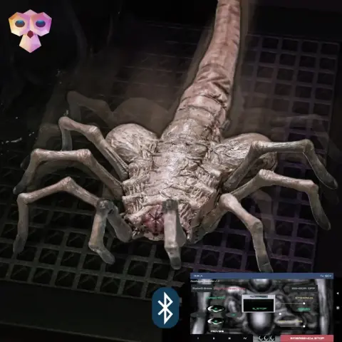 3D-printed Facehugger model with multiple legs and a long tail, resembling a creature from a sci-fi movie.