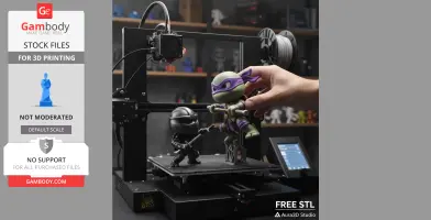 3D printer with Donatello figurine from Ninja Turtles, held by a hand, and a black ninja figure.