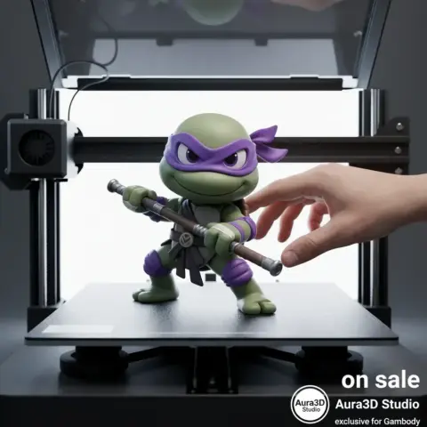 A 3D-printed Ninja Turtle figure, Donatello, on a printer bed with a hand adjusting it.