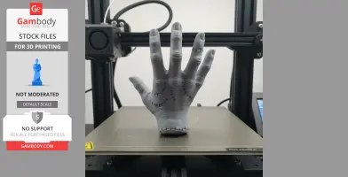 A 3D-printed, stitched hand prop on a printer platform, styled after the Thing character.