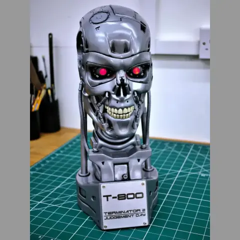 Terminator T-800 skull model with red eyes on a base for 3D printing, labeled 'Terminator 2 Judgment Day.'