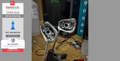 Two detailed metallic parts resembling the back of T-800 skull eyes, placed on a workbench.