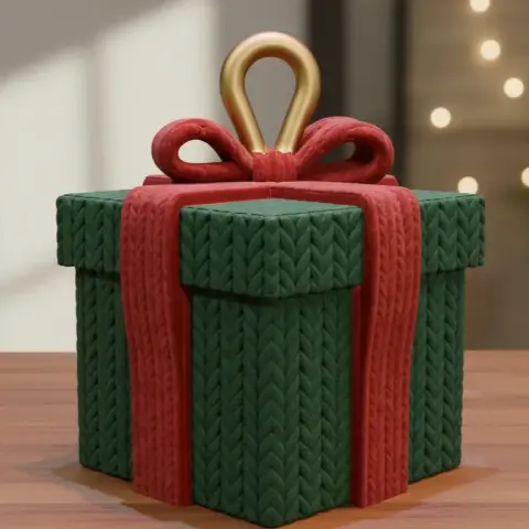 A 3D-printed gift box with a knitted texture, adorned with a red ribbon and golden loop.