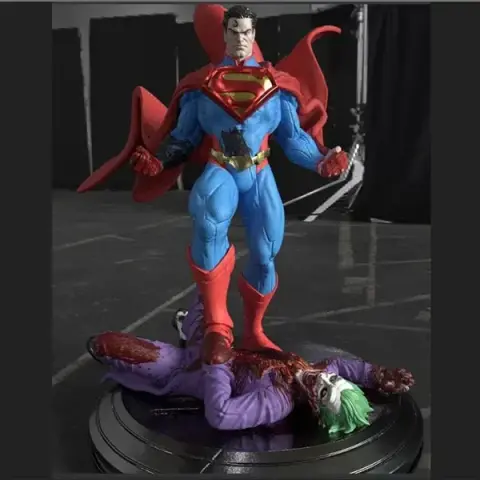 Superman triumphantly stands over a defeated Joker on a display base.