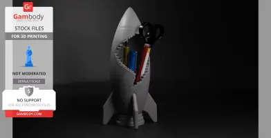 Cracked rocket-shaped desk organizer holding pens and scissors, designed for 3D printing.