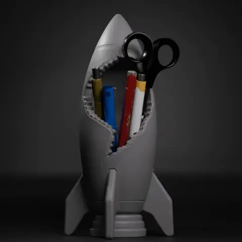 Rocket-shaped desk organizer holding scissors and pencils, with a cracked design.