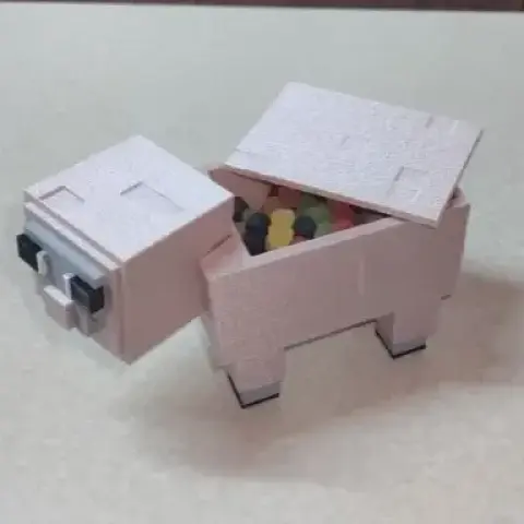 A blocky sheep figure with an open top holding colorful candies, designed for 3D printing.