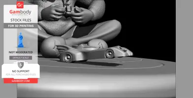Figure playing with a remote control car, seated cross-legged on a mat.