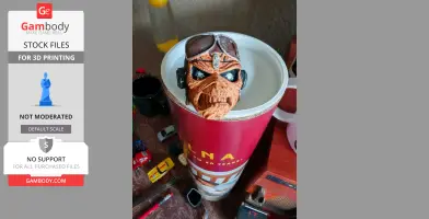 A detailed skull model wearing goggles, sitting in a red container, surrounded by small items.