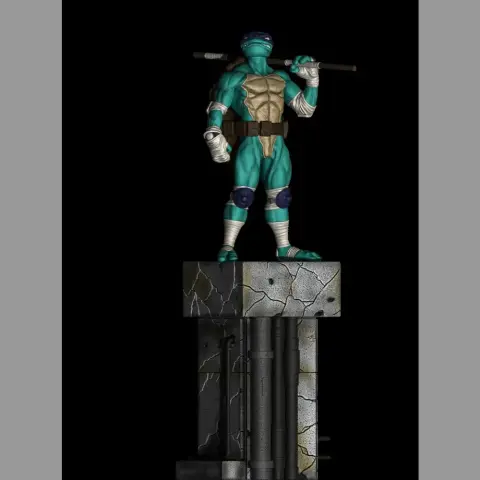 Ninja turtle action figure holding a staff, standing on a cracked platform.