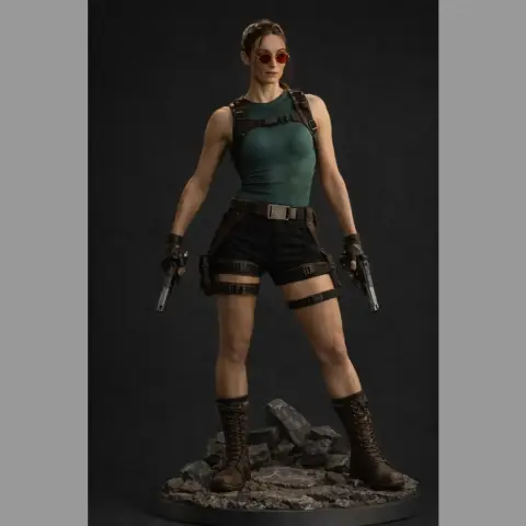 A 3D model of a female adventurer with guns, in rugged attire, standing on rocky terrain.