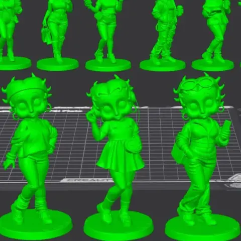 Two stylized humanoid figurines on bases; one has a dress, the other in a sailor outfit saluting.