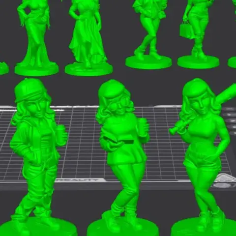 Two stylized female figurines in distinctive outfits, standing on themed bases.