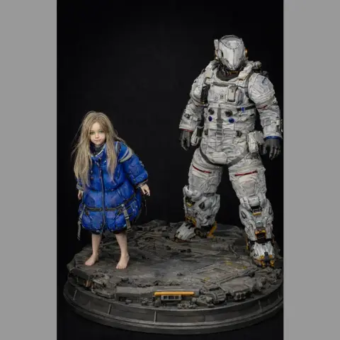 A 3D model of a girl in a blue coat and an armored astronaut on a detailed base.