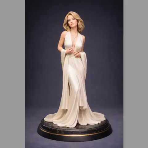 A 3D model of a woman in an elegant gown, standing on a decorative round base.