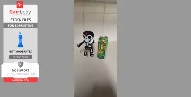A skeletal Day of the Dead puppet figurine beside an energy drink can.