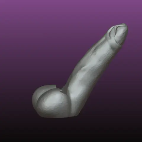 A sculpted phone stand resembling a phallic shape on a purple background.