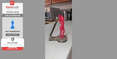 A red 3D-printed spacegirl figure on a base, serving as a mouse bungee holder.