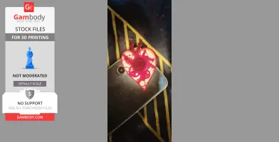 A 3D-printed red heart shape with intricate gears, resting on a smartphone.