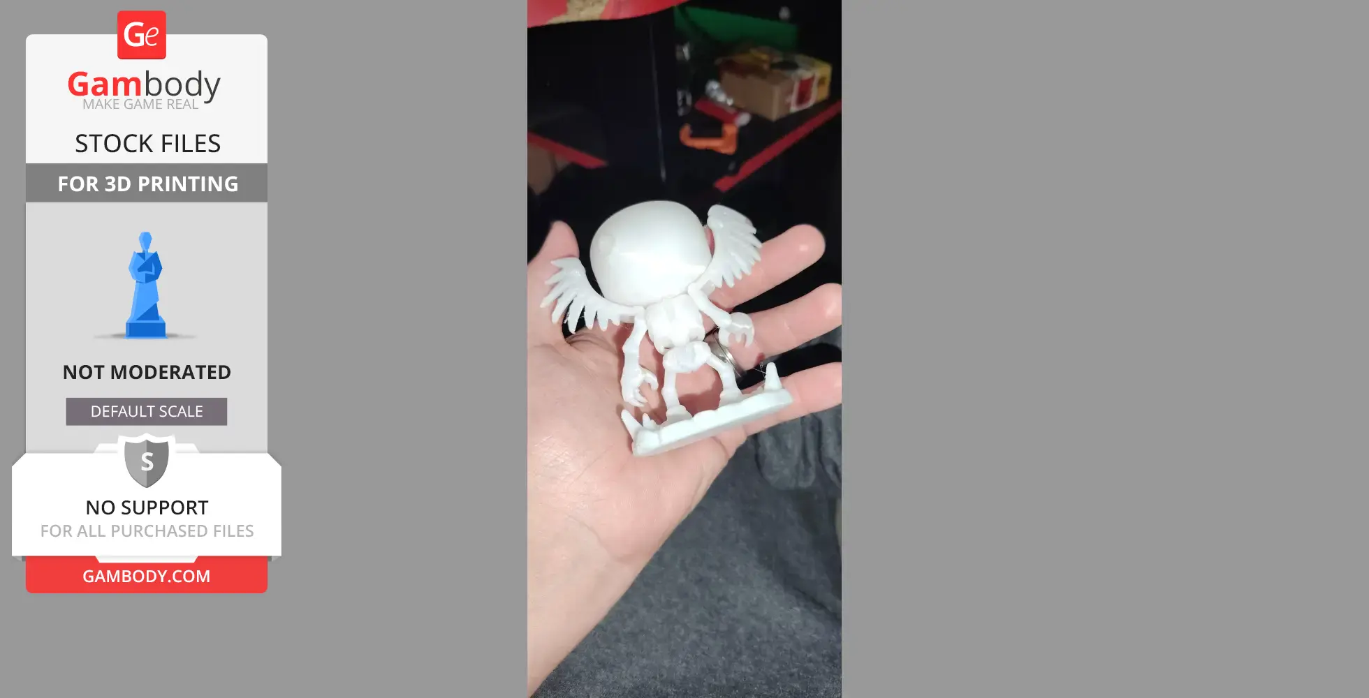 A small, 3D-printed figure with wings and a large head, held in a person's hand.