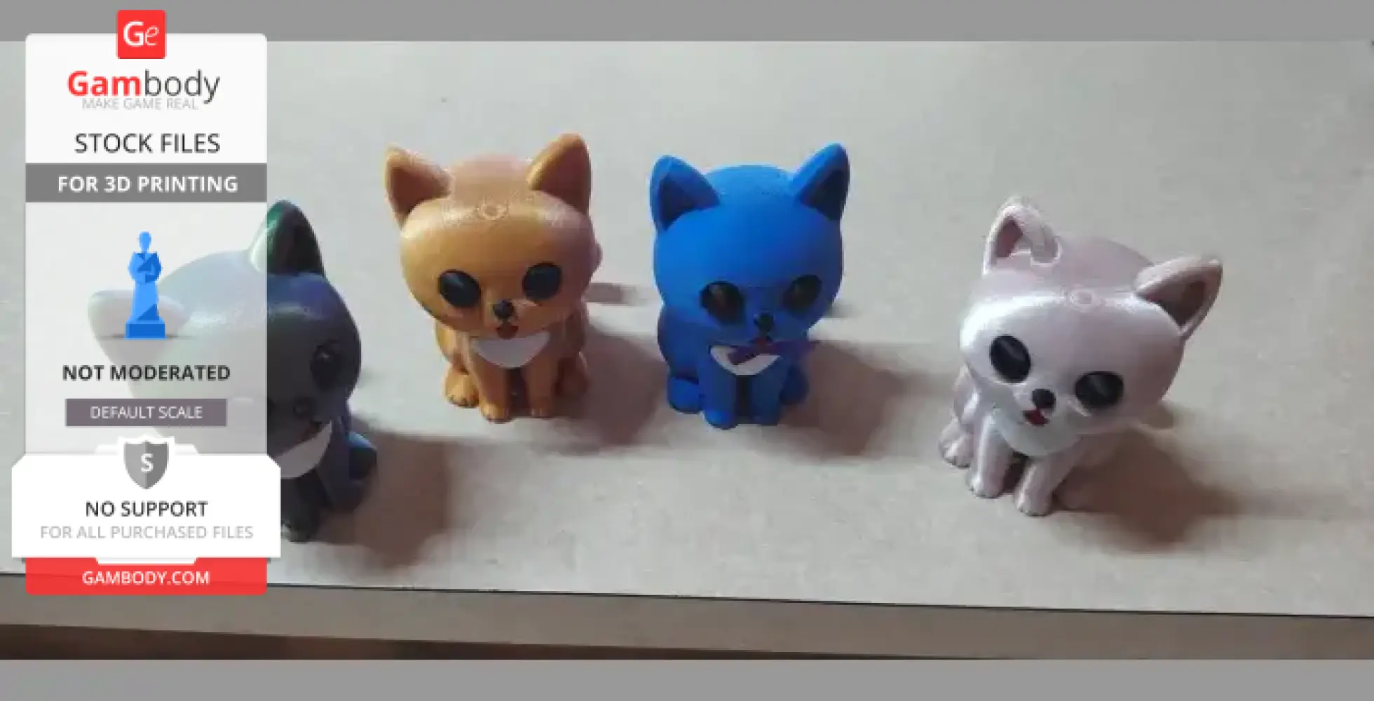 Four colorful, cartoonish 3D-printed cat models on a table.