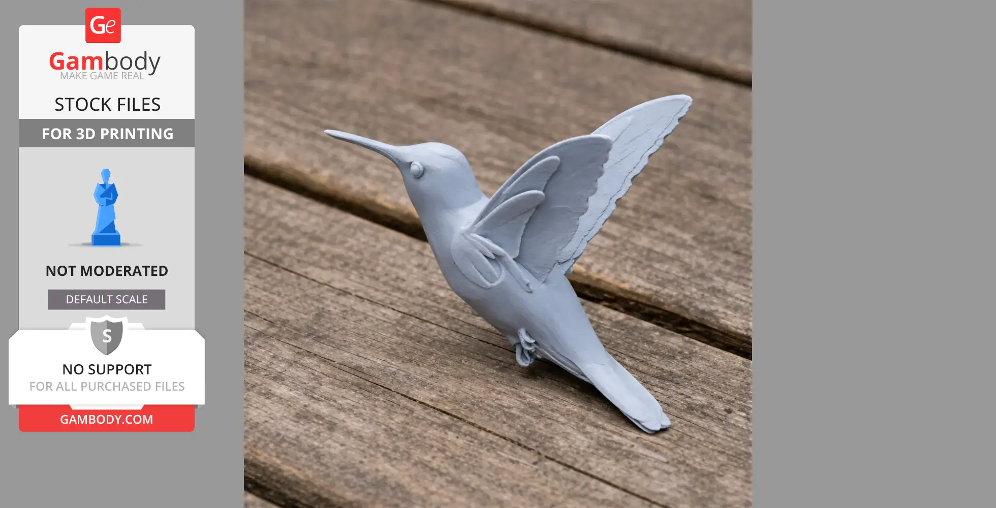 A gray 3D-printed hummingbird model with spread wings, perched on a wooden surface.