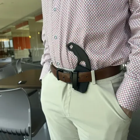 3D models of a clip, knife, and holster parts on a grid plane for printing.