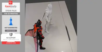 Two Batman armor models, one black and red, one white, displayed on a surface for 3D printing.