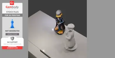 Daffy Duck in mobster attire, colorful and grayscale 3D models for printing, displayed on a table.