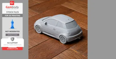 3D-printed scale model of a hatchback car on a wooden surface.