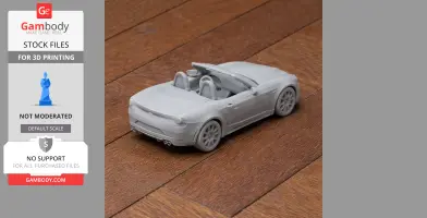 3D-printed Abarth 124 Spider scale model, convertible, on wooden surface.