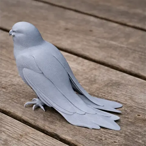 A detailed 3D-printed model of a kestrel bird with elaborate feather textures, perched on a wooden surface.