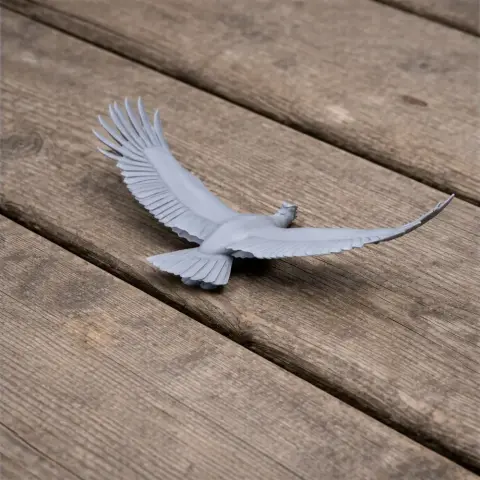 3D printed model of an Andean Condor with outstretched wings on a wooden surface.