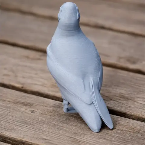 3D printed model of an Atlantic Puffin, unpainted, standing on a wooden surface.