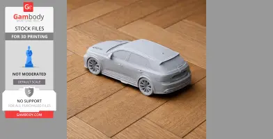 A gray 3D printed model of a sports car on a wooden surface.